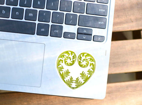 image shows a laptop with a Fern leaf vinyl sticker for your water bottle, laptop, car sticker, journal, window, or other smooth surface.