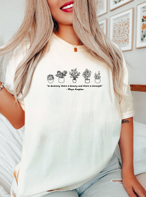 Woman wearing a t-shirt that reads "In diversity, there is beauty & there is strength. -Maya Angelou."
