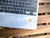 Image shows a laptop with a white daisy decal.